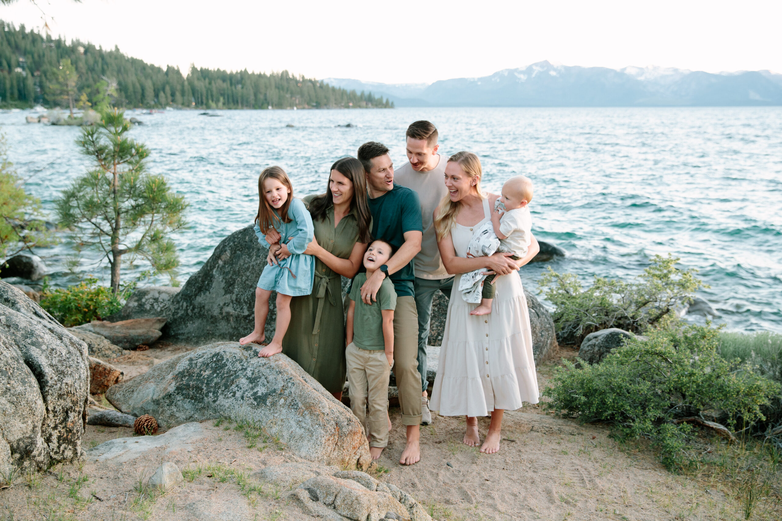 Two families laughing together on the Zephyr Cove shoreline session at Lake Tahoe.